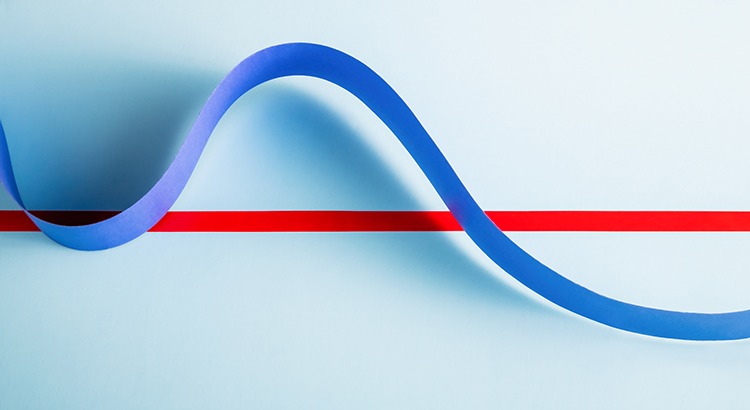 Long strip of blue paper in wave pattern flowing over red line